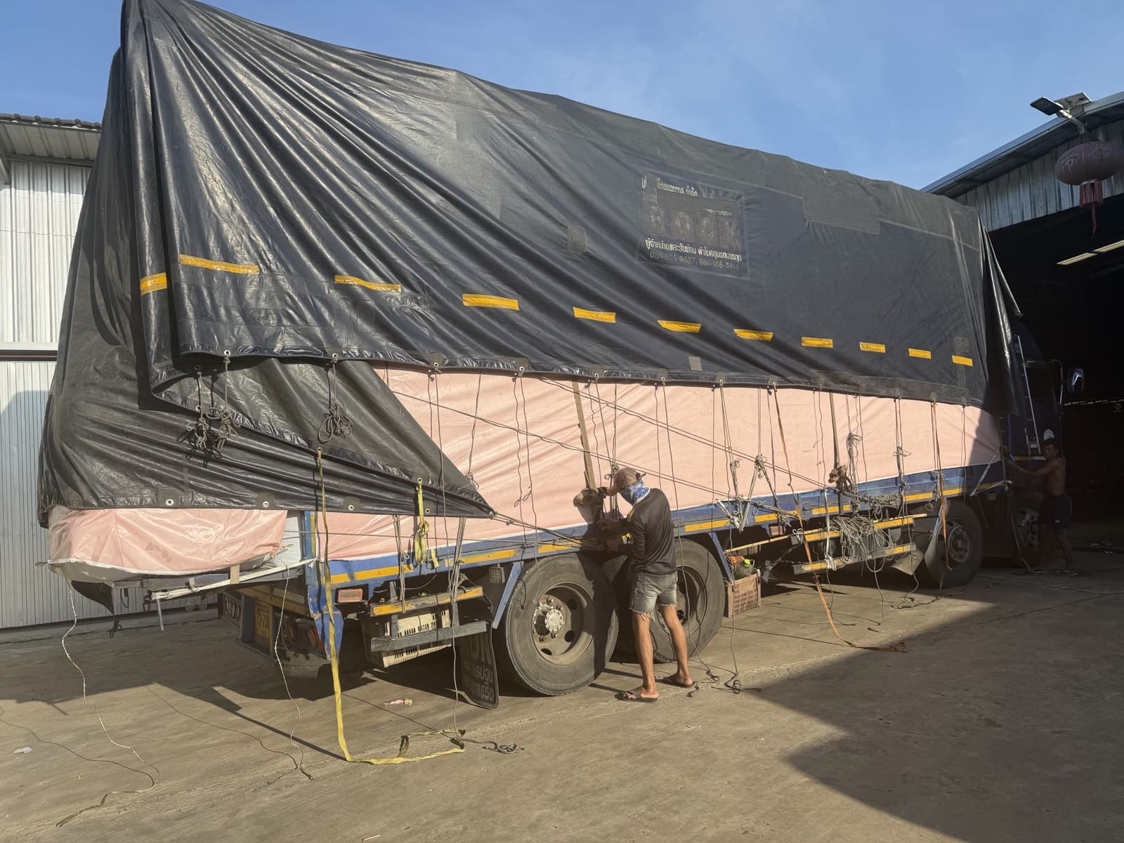 Trucks loaded and tarped, ready to leave the factory yard
