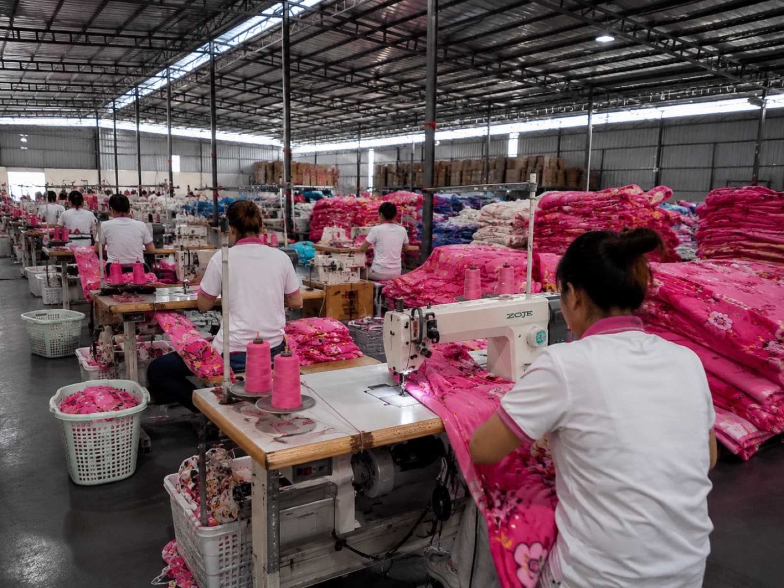 Large production workshop with hundreds of workers sewing bedding